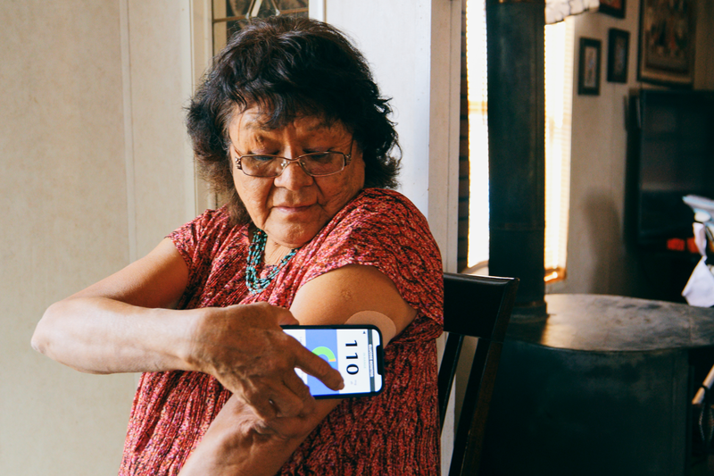 Senior Woman Checking Blood Glucose Level on an App - stock photo
A senior aged Indigenous Navajo woman, checking her blood glucose level with a smartphone application.
