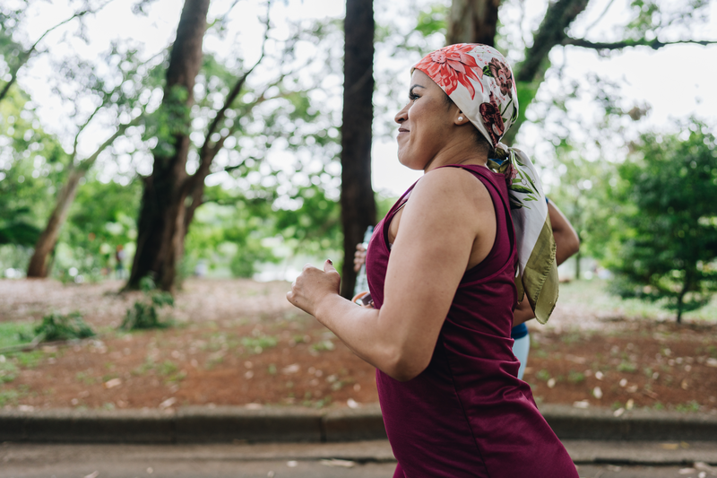 A mature woman who is battling cancer jogging at park - stock photo
A mature woman who is battling cancer jogging at park