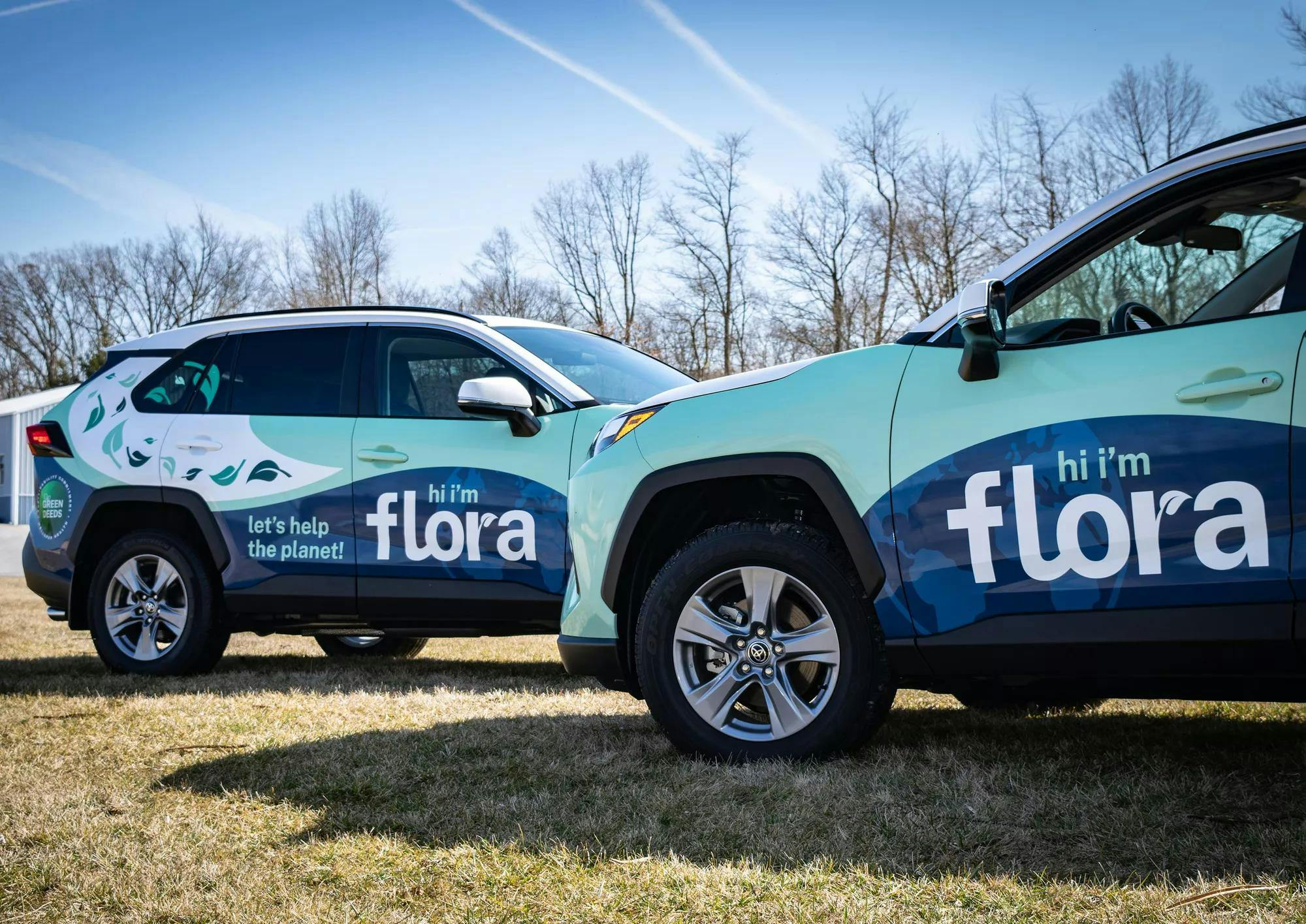 Photos of two TOYOTA RAV 4 vehicles wrapped for our sustainability initiative. The vehicle is named FLORA