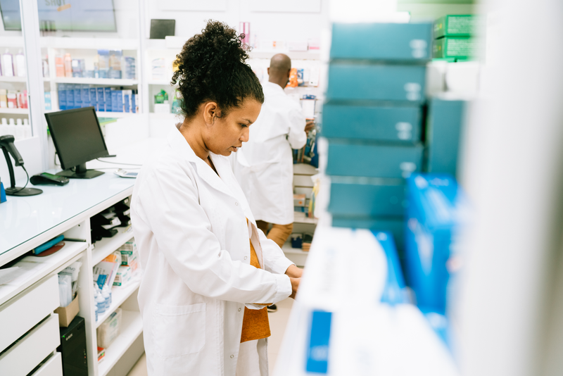 Pregnant Pharmacist working - stock photo
Pregnant pharmacist searching for medicine on pharmacy shelves