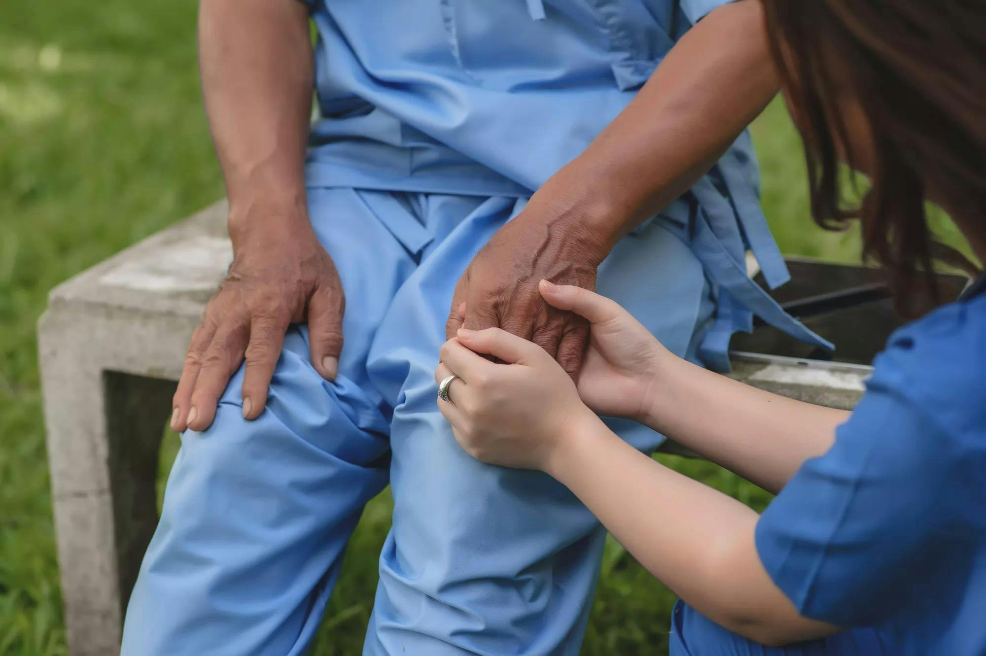 Female Doctor Touching Hand of the Senior Patient to Give Encouragement while Maintaining Physical Health Rehabilitation. Science of Touch. Selective Focus on Hands.