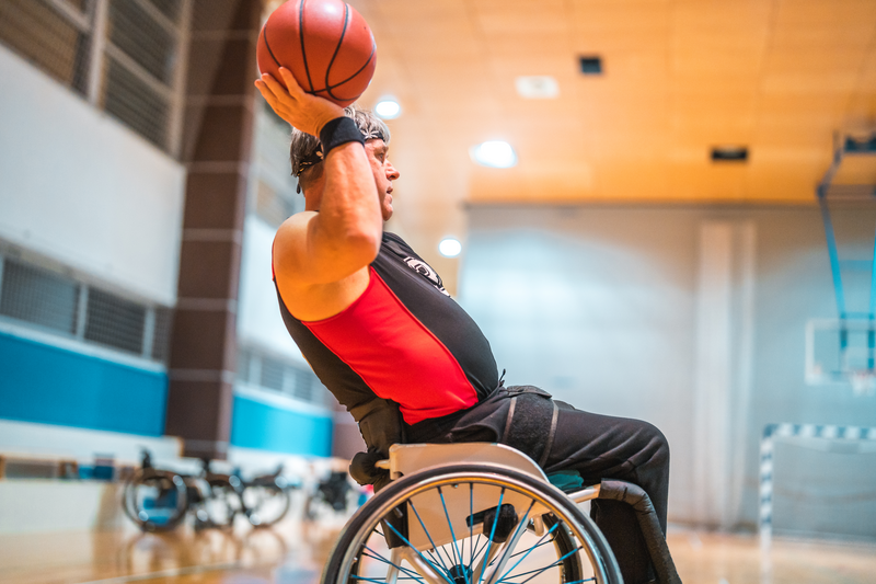 Male Wheelchair Basketball Player Passing The Ball - stock photo
Low angle view of male wheelchair basketball players passing the ball during practice.