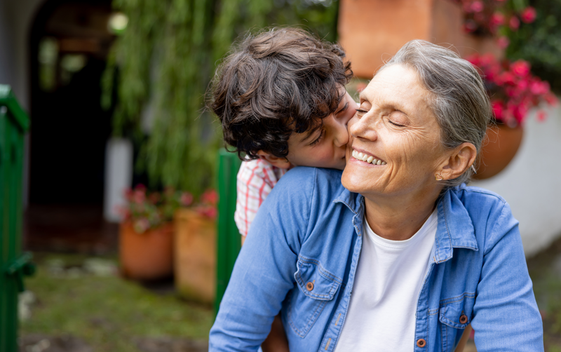 Loving grandson giving a kiss to his grandmother - stock photo
Portrait of a loving grandson giving a kiss to his grandmother outdoors - family concepts